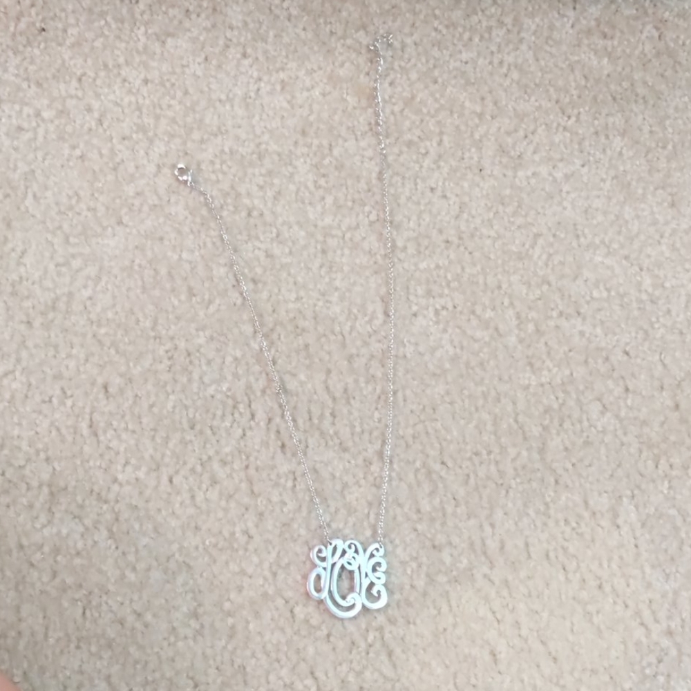 Silver necklace, spells out "Love"